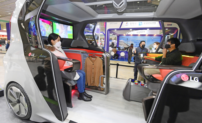 Visitors inside LG Electronics' car concept during the Korea Electronics Show 2020.
