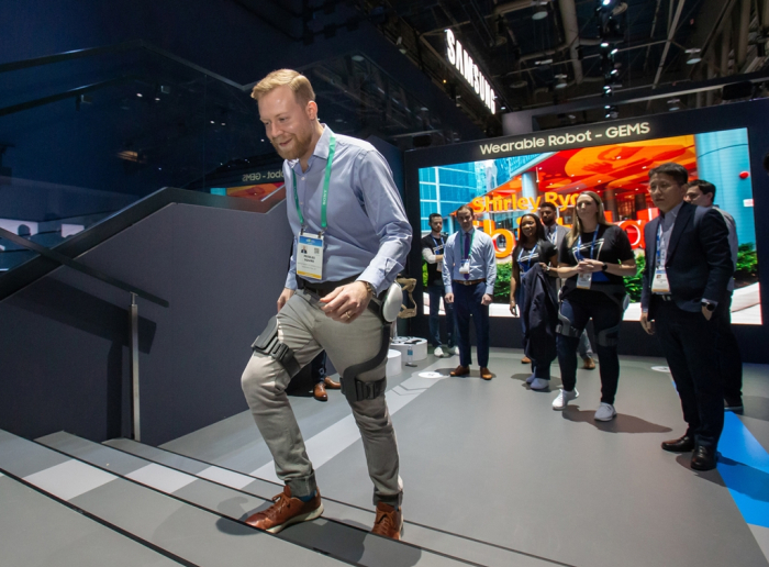 A visitor walks wearing the GEMS Hip at CES 2020.
