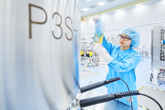A Samsung Biologics’ official is checking a device at its plant