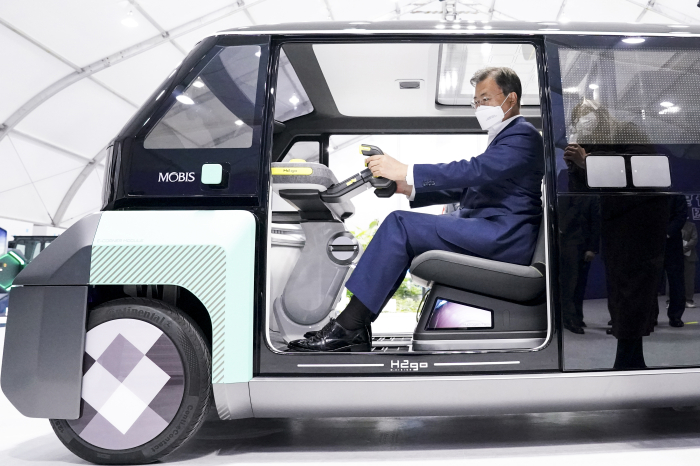 President Moon Jae-in test drives a Hyundai Mobis hydrogen-fueled vehicle