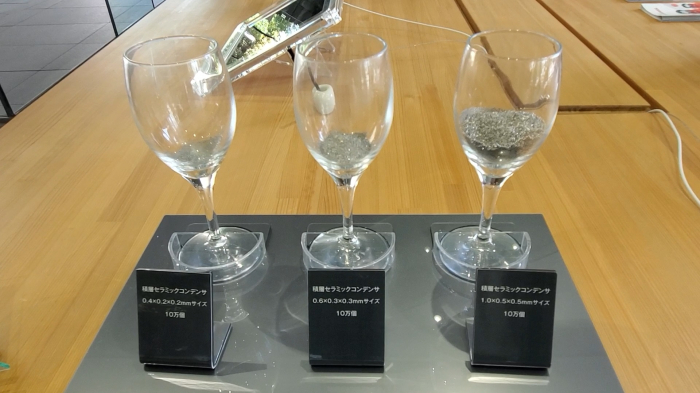 Multilayer ceramic capacitors (MLCCs) inside wine glasses on display at Murata Manufacturing's headquarters in Kyoto