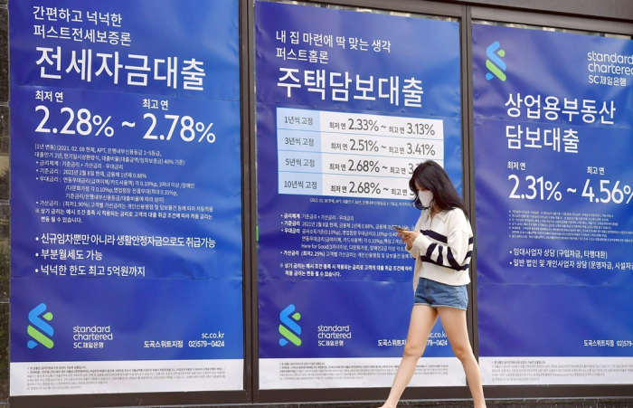 A　Standard　Chartered　Bank　Korea’s　branch　in　Seoul　shows　interest　rates　on　property　loans.