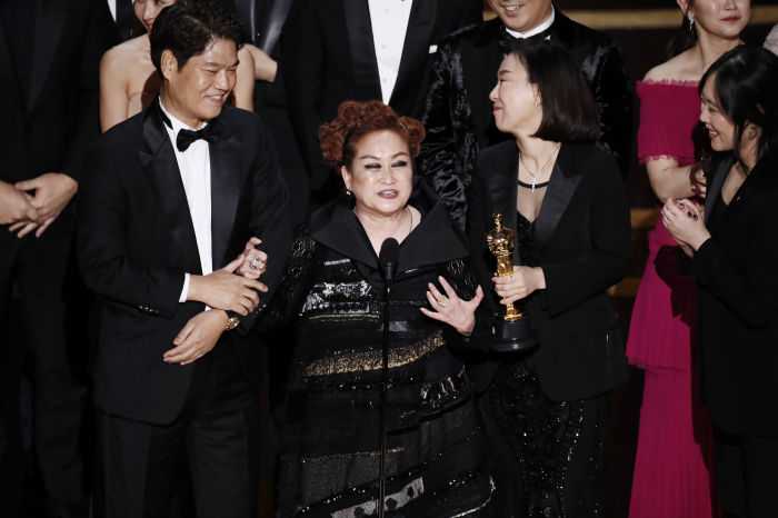 CJ　Group　Vice　Chairman　Miky　Lee　(center)　speaks　after　'Parasite'　wins　the　Oscar　for　best　picture　in　2020.　CJ　ENM　distributed　the　film.