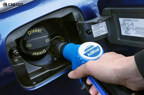 A　driver　replenishes　diesel　exhaust　fluid