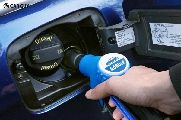 A driver replenishes diesel exhaust fluid