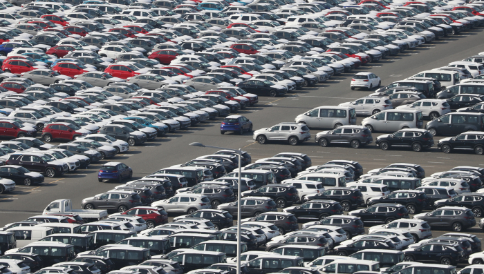 Cars wait for loading on cargo ships