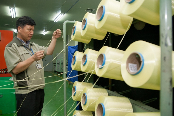 A Kolon employee checks aramid at its factory in Gumi, South Korea