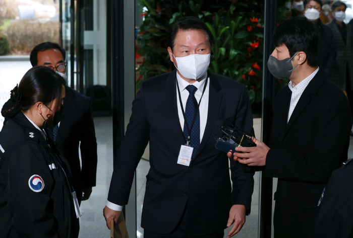 SK Group Chairman Chey Tae-won attends an FTC session over allegations of an unfair business practice