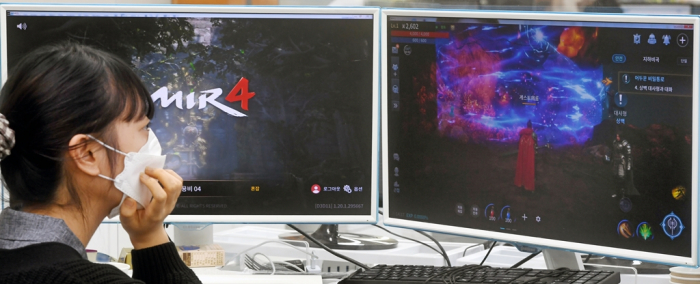 A gamer is looking at Wemade's Mir4, a play-to-earn (P2E) game
