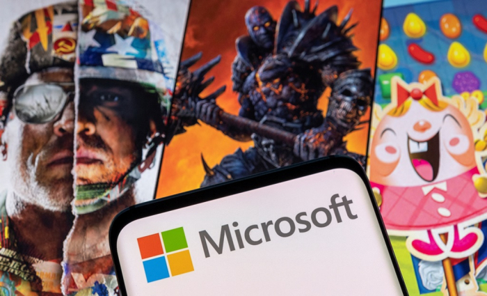 Microsoft　logo　is　seen　on　a　smartphone　placed　on　displayed　Activision　Blizzard's　games　characters　in　this　illustration　taken　Jan.　18.　(Courtesy　of　Reuters,　Yonhap)