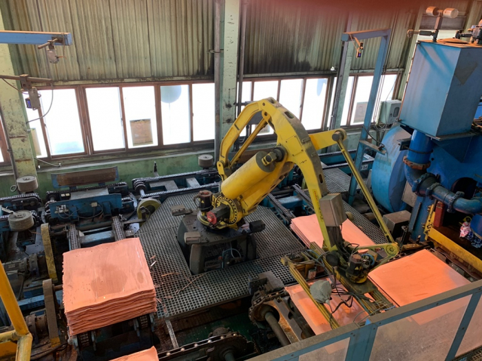 A robot moves a copper product at LS-Nikko Copper Co.