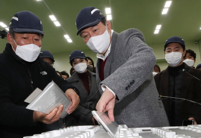 South Korea’s President-elect Yoon Suk-yeol (middle) on Nov. 30, 2021 visits a small producer of secondary batteries. Yoon pledges to prohibit new registrations of internal combustion engine vehicles from 2035 in South Korea.