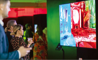 Viewers view NFT artwork on a LG smart TV screen