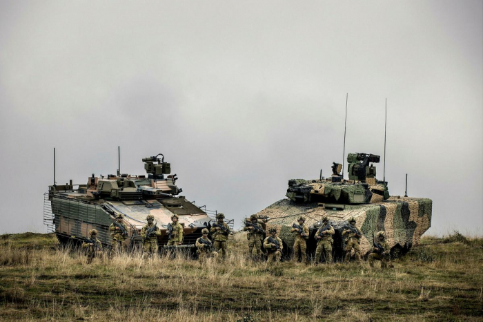 Australian soldiers stand in front of Hanwha's Redback IFV (left) and Rheinmetall's Lynx KF-41 IFV (Courtesy of Australian Department of Defence)