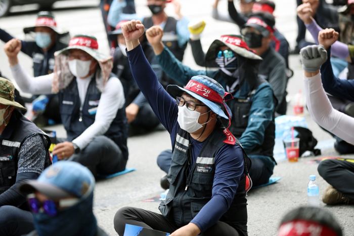 Members of the Cargo Truckers Solidarity union protest outside Kia's auto plant in Gwangju