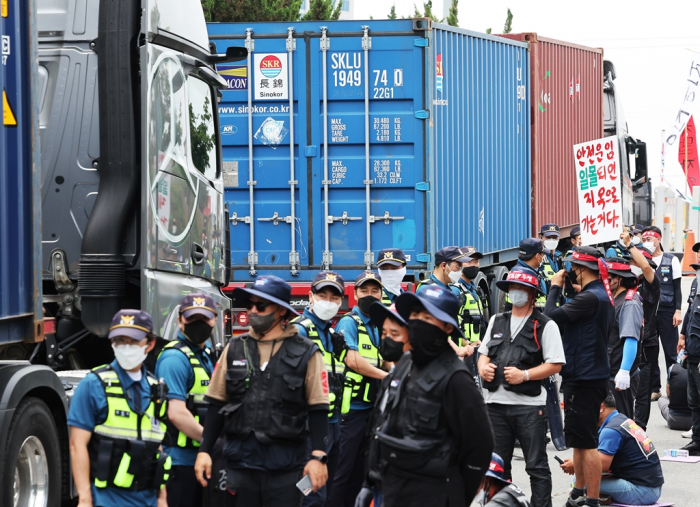 Striking truck drivers hold a rally