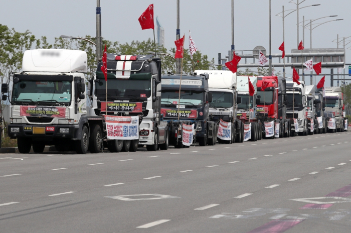 A long line of trucks parked near an Incheon airport