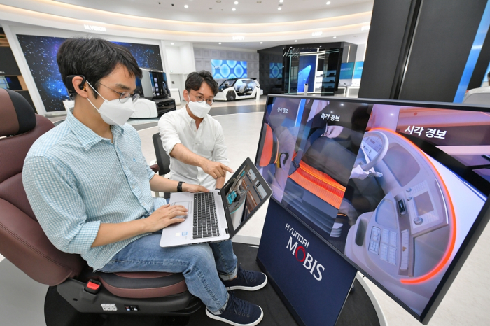 Hyundai Mobis engineers check the M.Brain system installed in a car