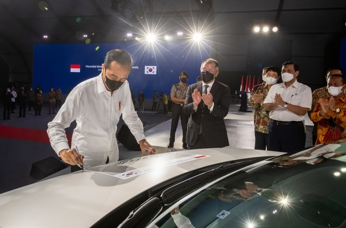 Indonesian President Joko Widodo signs on the IONIQ 5 at the opening of Hyundai Motor's Indonesian plant