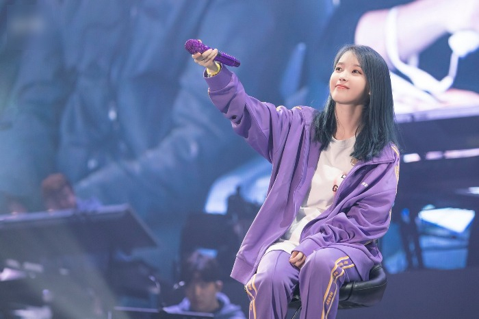 K-pop megastar IU sporting a tracksuit in fashion brand Nerdy's signature shade of purple (Screenshot of YouTube channel WolAhJoUn)