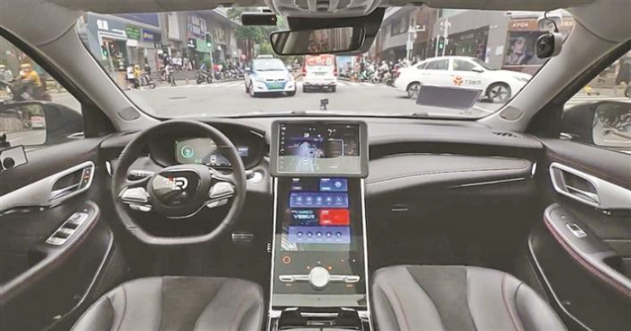 The car with autonomous driving system drives itself on a street in Shenzhen, Guangdong province, China (Courtesy of Shenzhen government)