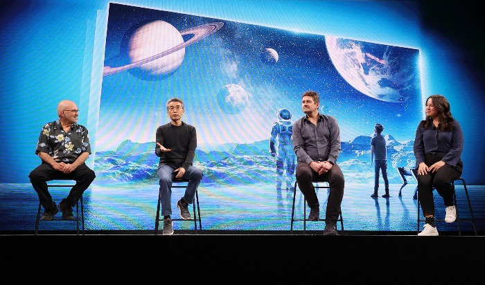 Chairman of Boston Dynamics Marc Raiber (far left) and the head of Hyundai Motor Group's TaaS division Song Chang-Hyeon (second from left) speak at a press conference in Las Vegas, Nevada on Jan. 5, 2022