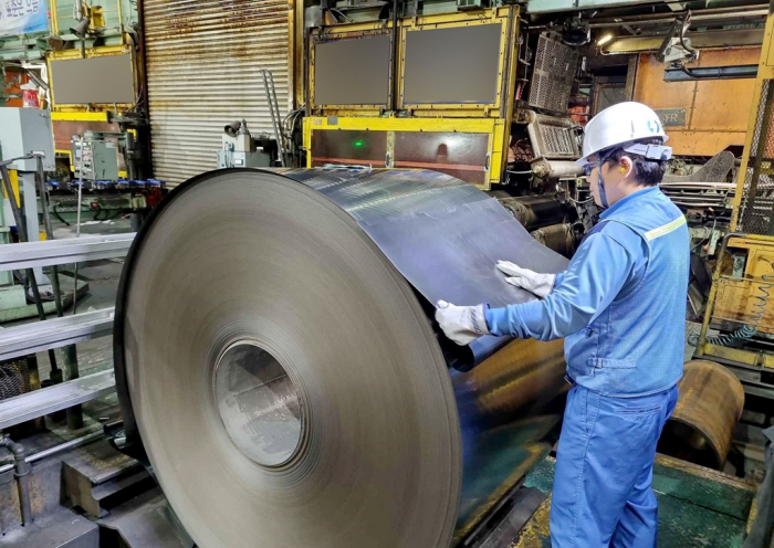 A POSCO staff inspects the first product from a restored electrical steel sheet production line on Sept. 15, 2022, at typhoon-hit Pohang Steel Works (Courtesy of POSCO)