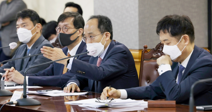 Finance Minister Choo Kyung-ho (third from left) speaks to the press after an emergency meeting