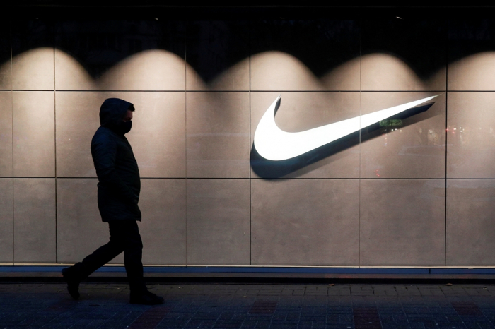 A man walks past a Nike brand store