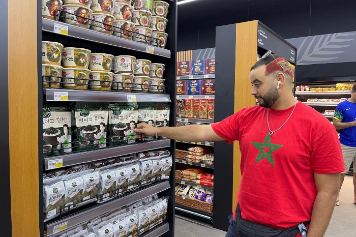 A　Qatari　man　checks　out　CJ　CheilJedang's　BIbigo　food　products　(Courtesy　of　CJ　Group)