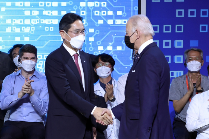 Samsung Group leader Jay Y. Lee shakes hands with US President Joe Biden at the chipmaker's Pyeongtaek plant during Biden's Korea visit in May 2022