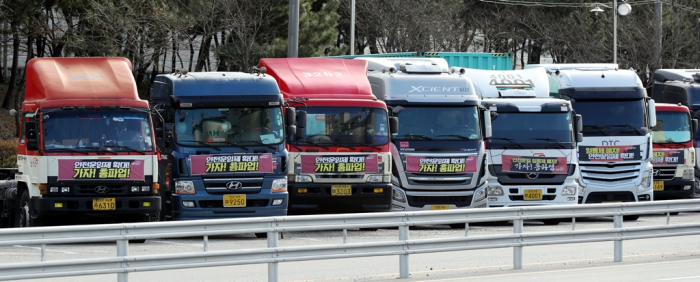 A long line of trucks parked near a cement company in Korea