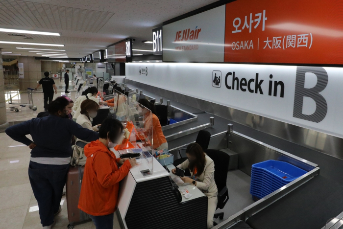 Passengers　check　in　at　the　Jeju　Air　counter　at　Gimpo　International　Airport　in　Seoul　for　a　flight　to　Osaka　on　Oct.　30,　2022　(News　1)