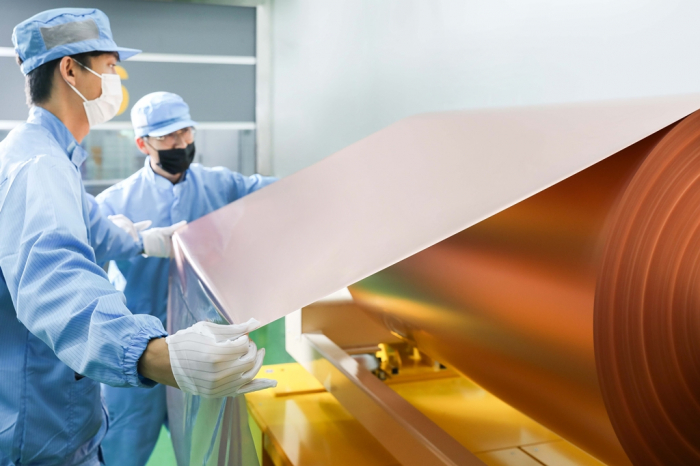 SK　Nexilis　employees　check　copper　foil　at　its　Korean　plant