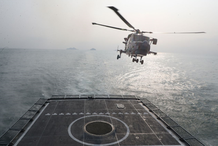 A helicopter takes off from the South Korean Navy’s destroyer during live-fire drills in waters off Taean, South Korea