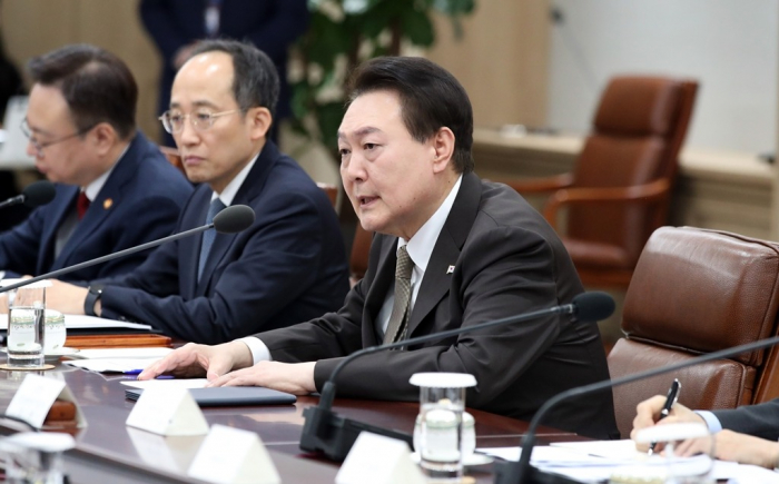 South Korean President Yoon Suk-yeol (middle) presides over a meeting of the country’s economy ministers on Feb. 15, 2023. Finance Minister Choo Kyung-ho sits next to Yoon on his right