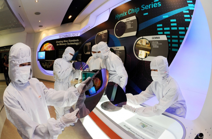 SK Hynix employees examine chip wafers