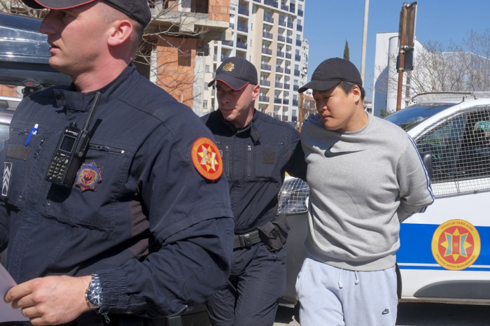 Montenegrin police officers escort Terraform Labs co-founder Do Kwon in Montenegro's capital Podgorica on March 24, 2023