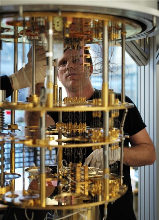 A researcher at IBM's Thomas J. Watson Research Center inspects the cooling system of an IBM quantum computer (Courtesy of IBM)