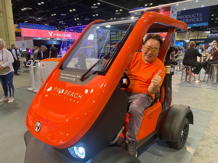 INNODESIGN CEO Kim Youngse sits in INNO-F1 at the 2023 PGA Show (Courtesy of INNOMOBILITY Lab)