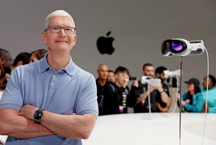 Apple CEO Tim Cook stands next to the new Apple Vision Pro headset during the Apple Worldwide Developers Conference on June 5, 2023