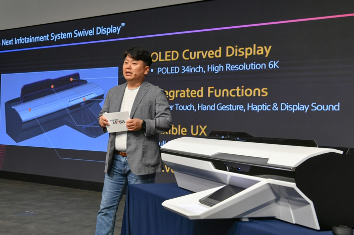 Hyundai Mobis’ electronics device chief Han Young-hoon showcases its swivel automotive display during the 2023 Media Tech Day