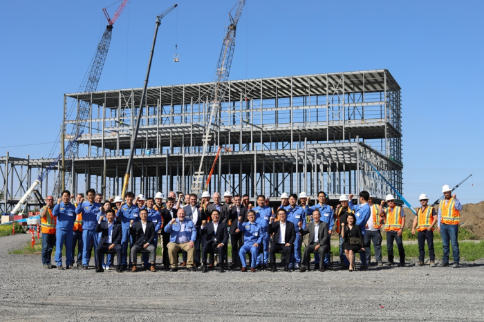 POSCO Chairman Choi (front, fourth from left) poses with workers at the construction site for POSCO Future M's cathode materials plant in Quebec on June 21