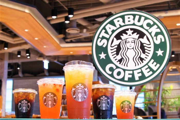 A Starbucks' iced drink in the Trenta size at center