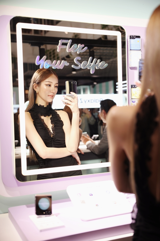 A visitor to a Samsung sales outlet in Seoul test its latest Galaxy Z Flip5 and Fold5 smartphones