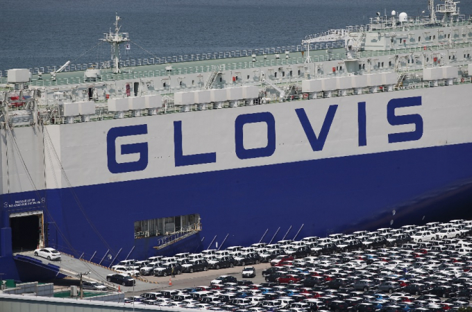 A Hyundai Glovis ship uploads cars at a Korean port for overseas shipment