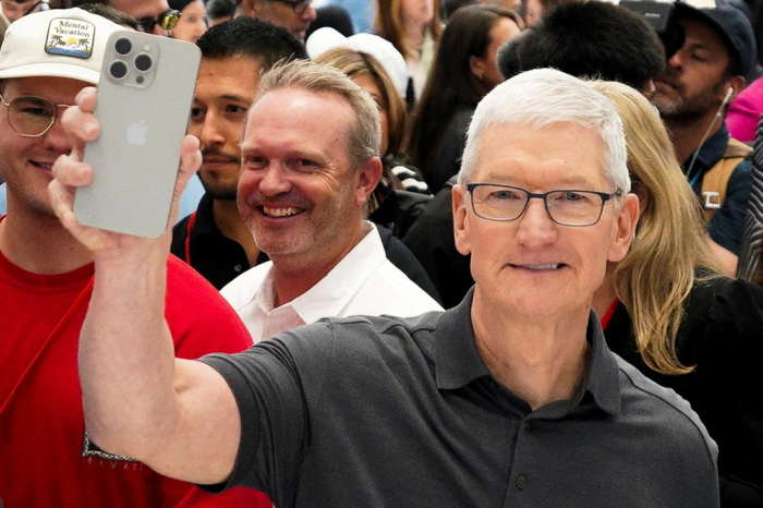 Apple CEO Tim Cook holds a new iPhone 15 Pro during the 'Wonderlust' event at the company's headquarters in Cupertino, California