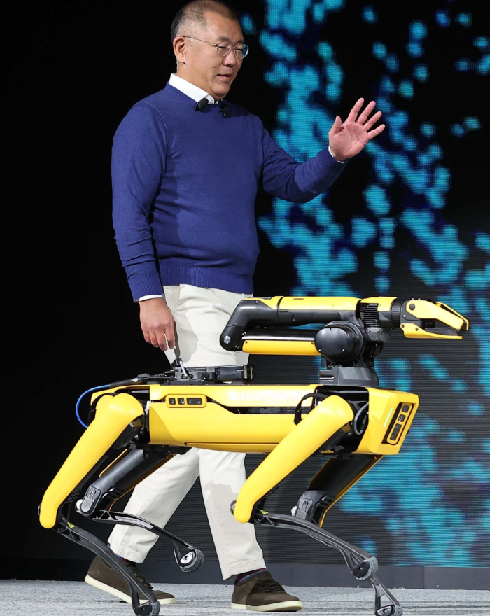 Chung Euisun walks with Spot, a four-legged robot