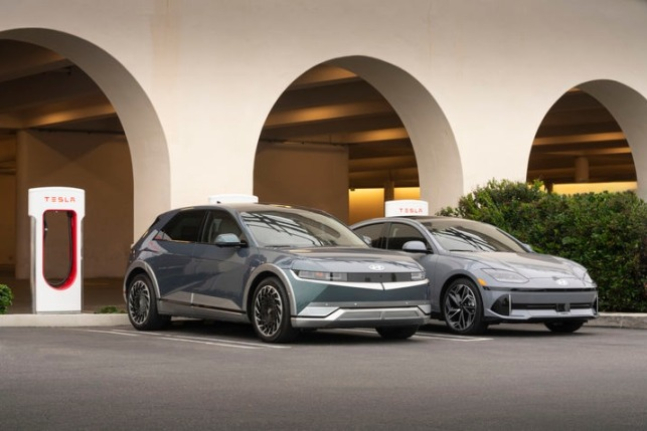 Hyundai Motor's IONIQ 5·6 parked in front of a Tesla’s Supercharger (Courtesy of Hyundai Motor)