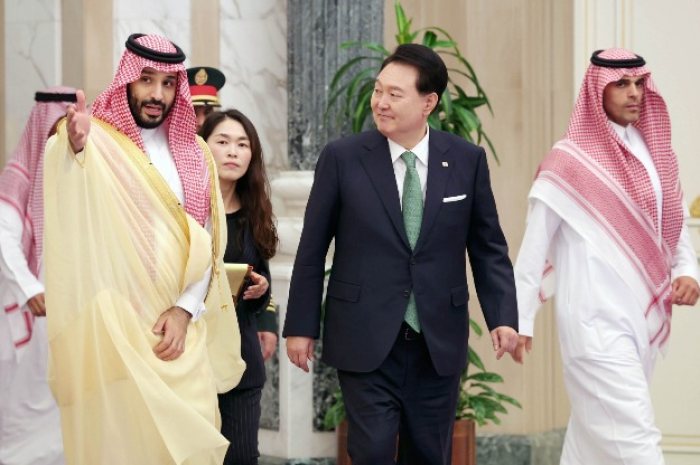 Saudi Arabia's Crown Prince Mohammed bin Salman (on left) visits with South Korean President Yoon Suk Yeol before the signing ceremony of dozens of MOUs in Riyadh on Oct. 22, 2023.